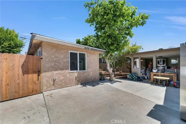 a view of a house with backyard sitting area and garden