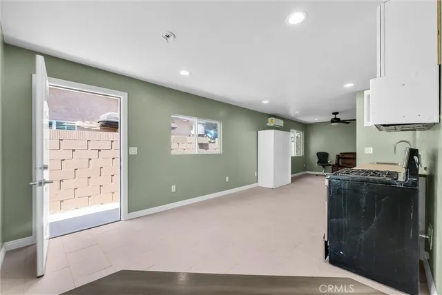 a kitchen with stainless steel appliances granite countertop a refrigerator a stove a sink and a microwave