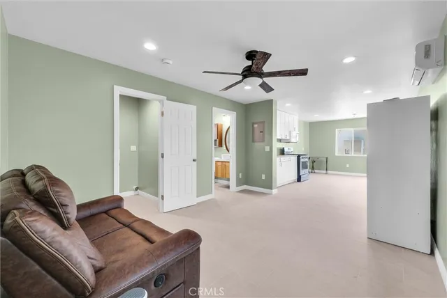a living room with furniture and a ceiling fan