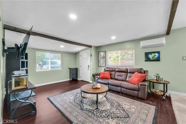 a living room with furniture a rug and a window