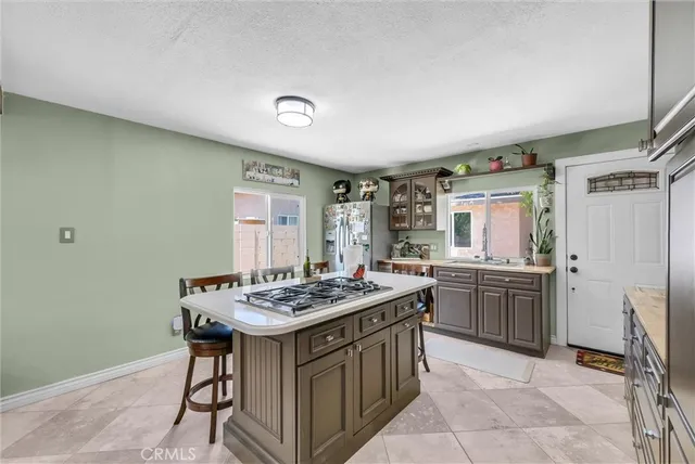 a kitchen with a stove a sink dishwasher and a refrigerator