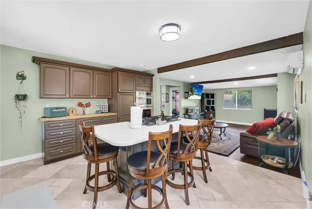 a kitchen with a dining table chairs and white cabinets