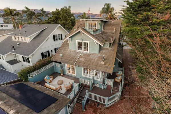 an aerial view of a house with a yard