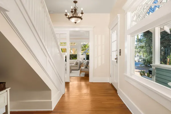 a view of a livingroom with wooden floor and stairs