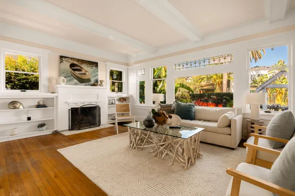 a living room with furniture large window and a fireplace