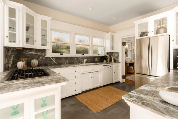 a kitchen with stainless steel appliances granite countertop a stove a sink and a refrigerator