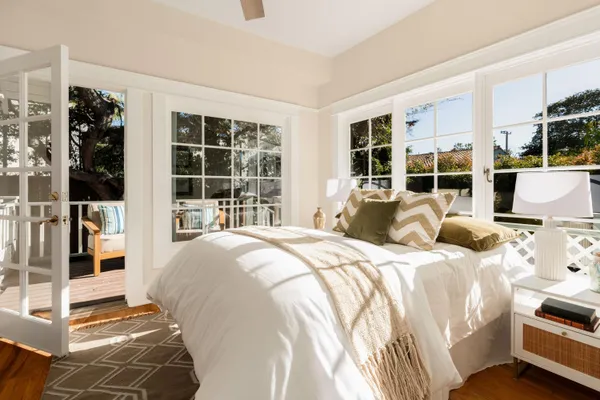 a large bedroom with a bed and glass window