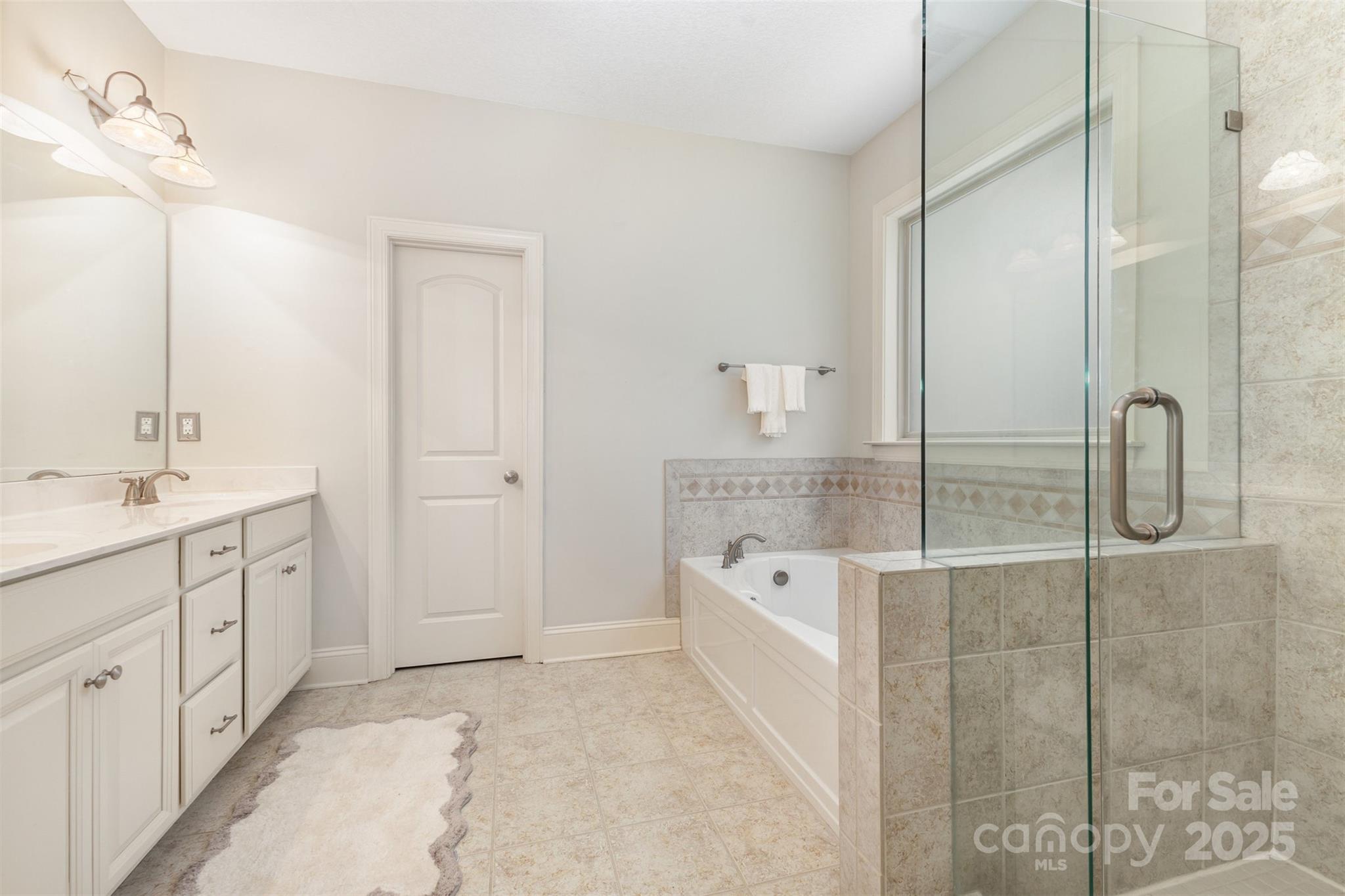 689 Presbyterian Road Mooresville, NC 28115 - Photo 18 of 34 a spacious bathroom with a tub sink and mirror