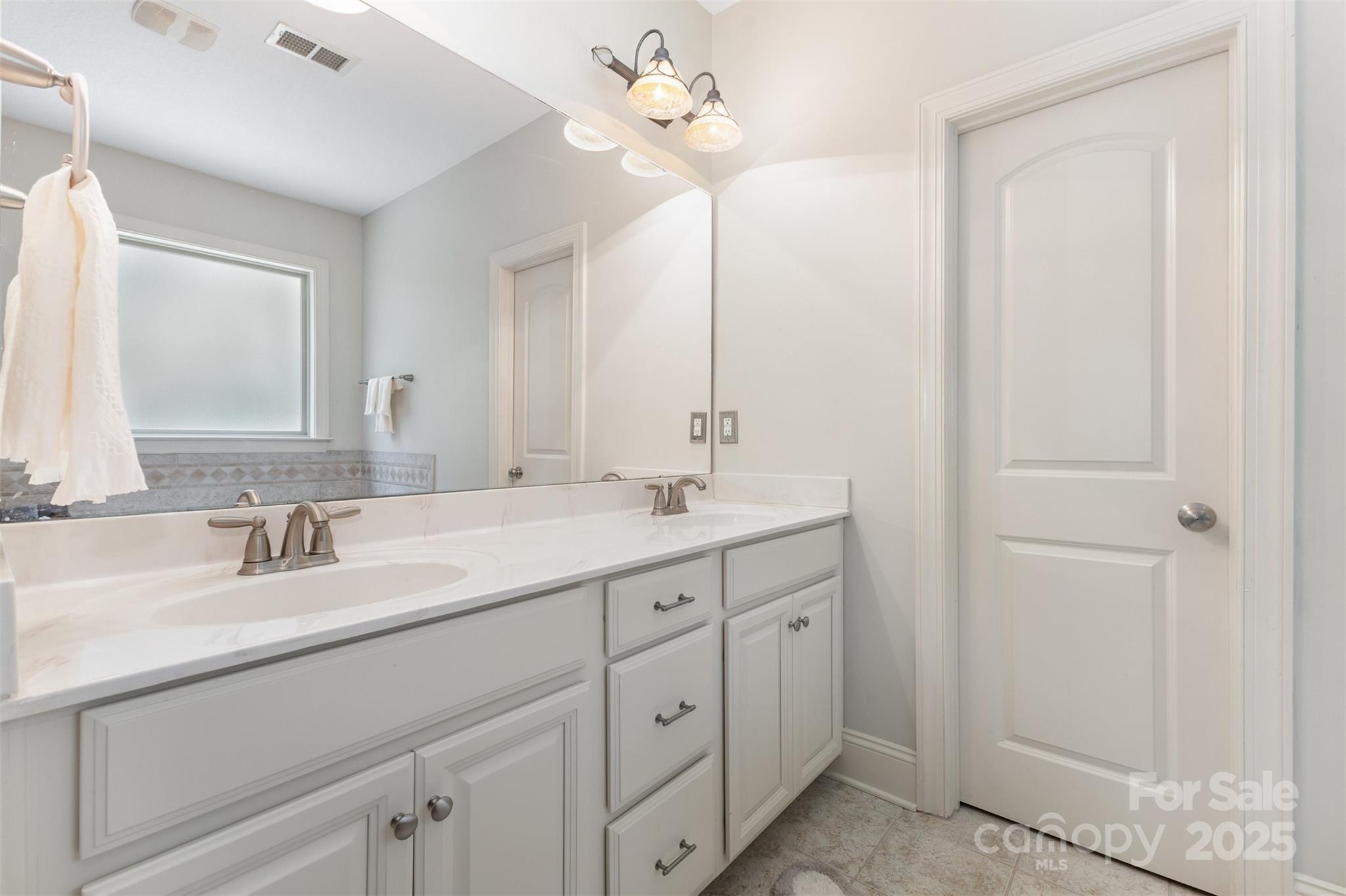 689 Presbyterian Road Mooresville, NC 28115 - Photo 19 of 34 a bathroom with a double vanity sink and a mirror