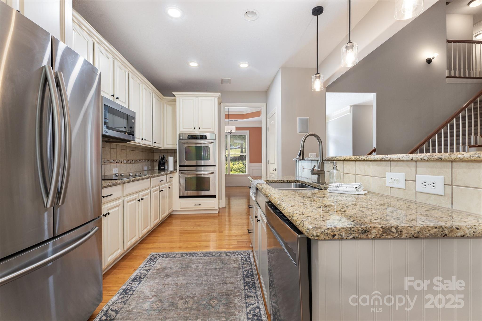 689 Presbyterian Road Mooresville, NC 28115 - Photo 7 of 34 a kitchen with stainless steel appliances granite countertop a sink stove and refrigerator