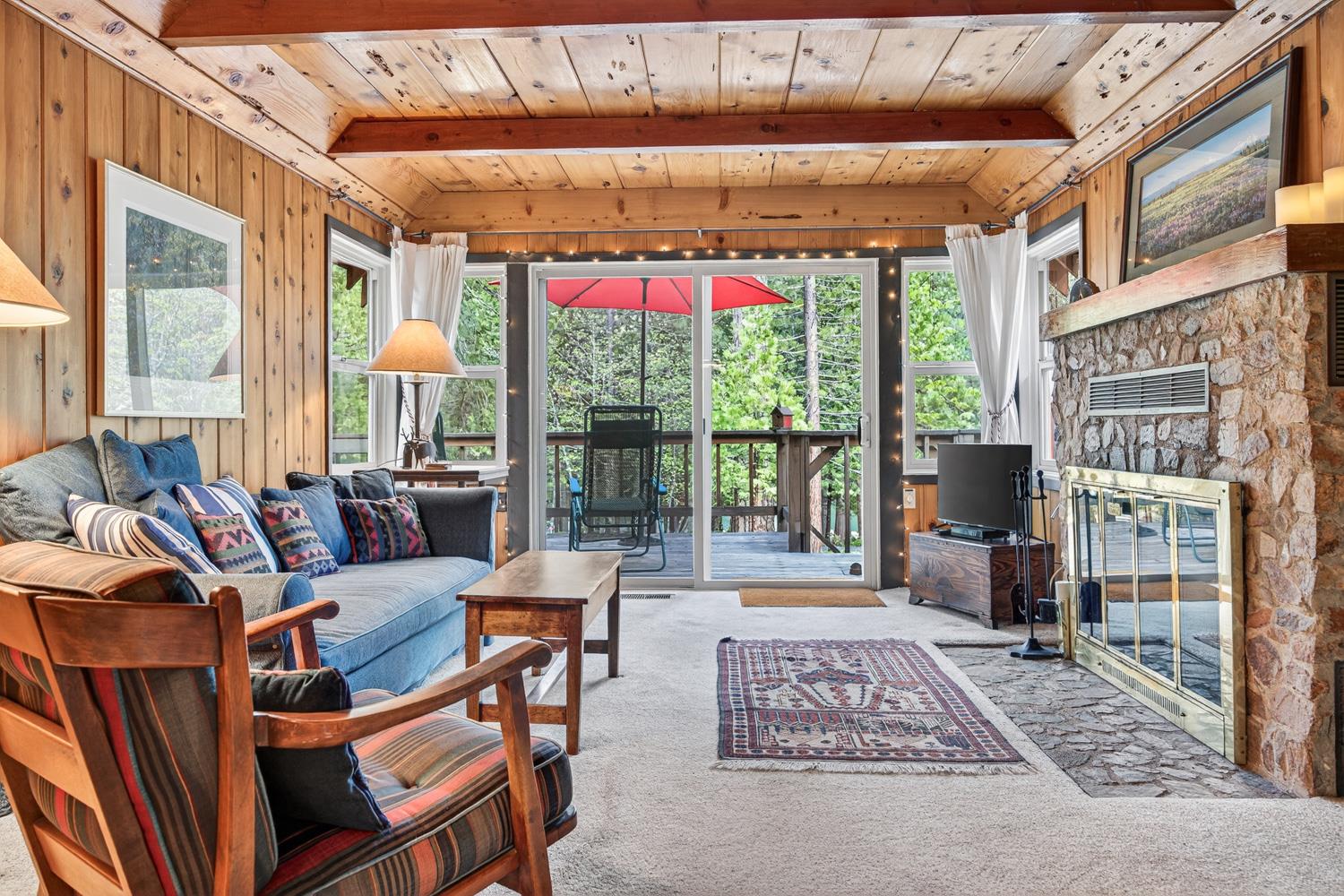 1224 Moran Road Arnold, CA 95223 - Photo 28 of 61 a living room with furniture and a floor to ceiling window