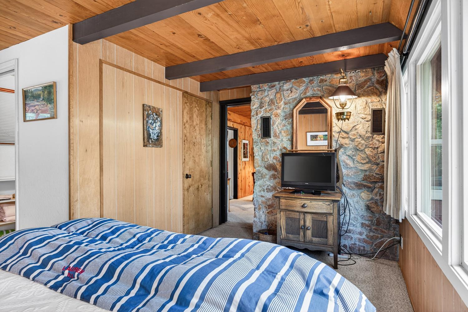 1224 Moran Road Arnold, CA 95223 - Photo 34 of 61 a bedroom with a bed and a flat screen tv