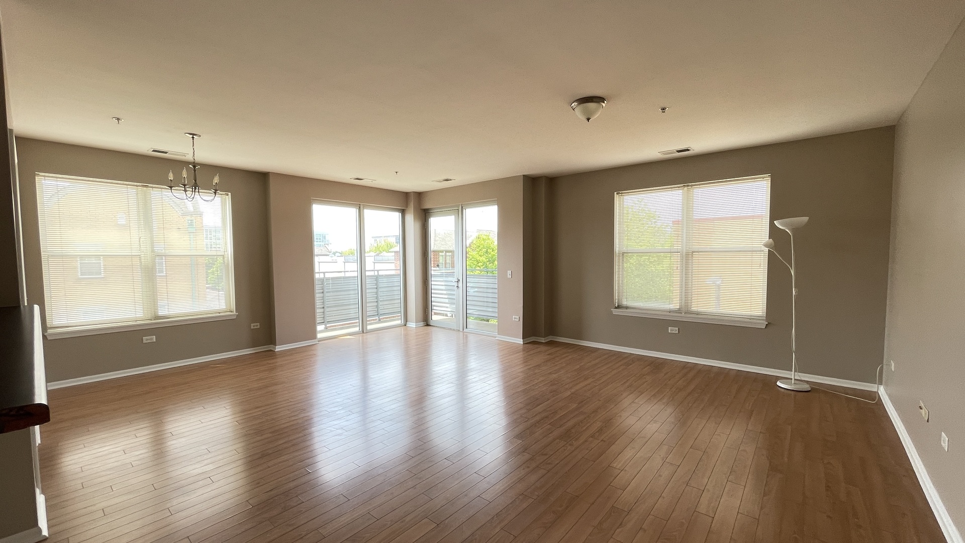 3522 South State Street, Unit 301 Chicago, IL 60609 - Photo 4 of 21 an empty room with wooden floor and windows
