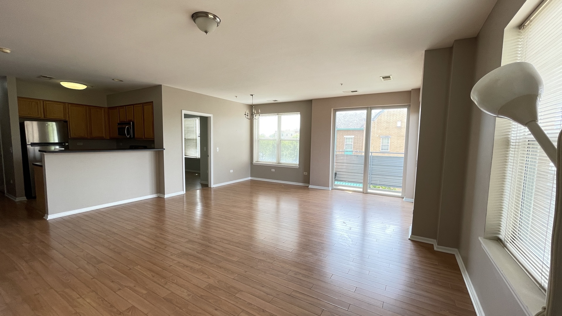 3522 South State Street, Unit 301 Chicago, IL 60609 - Photo 5 of 21 a view of an empty room with window and wooden floor
