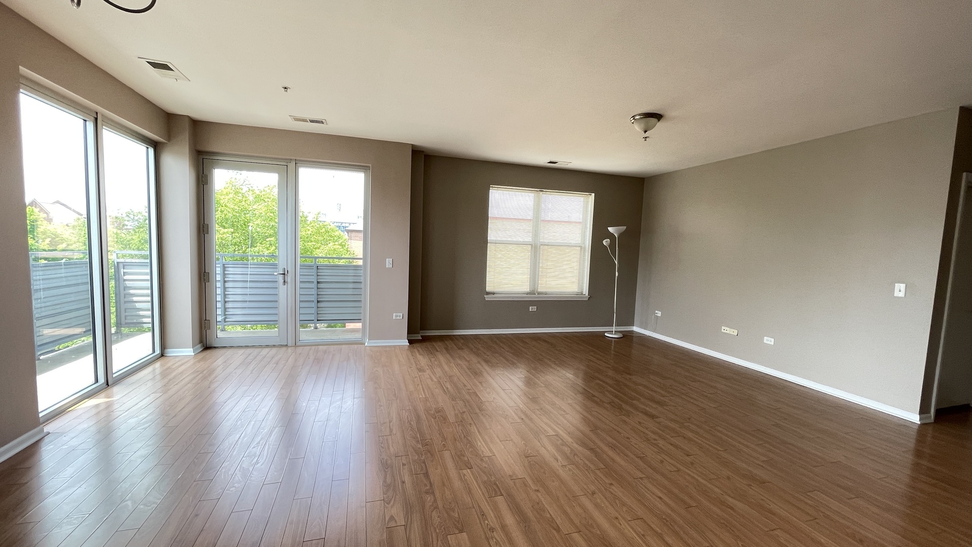 3522 South State Street, Unit 301 Chicago, IL 60609 - Photo 6 of 21 an empty room with wooden floor and windows