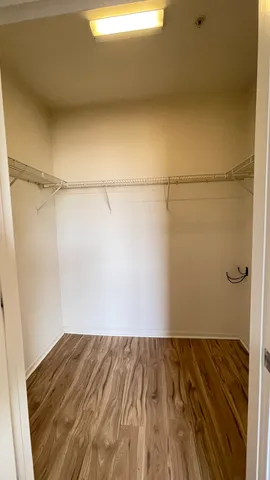 a view of a room with wooden floor