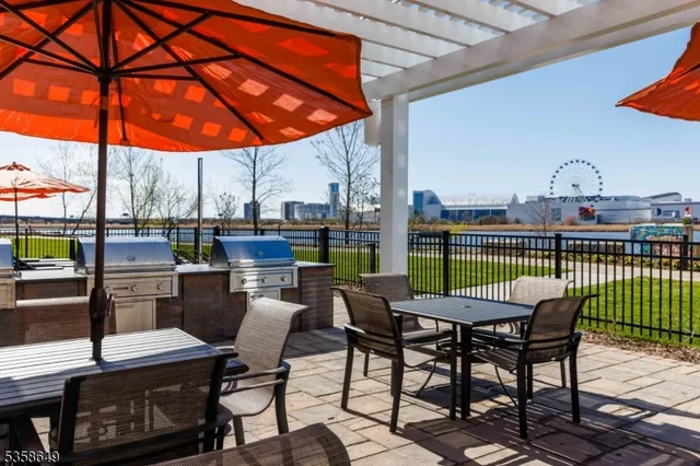 a view of a patio with a table chairs and a backyard