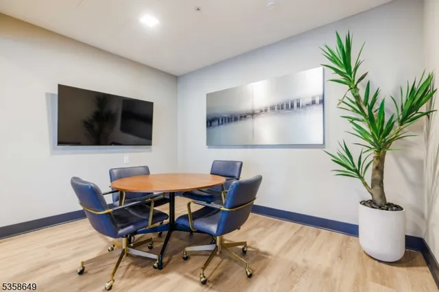 a view of a dining room with furniture and a flat screen tv