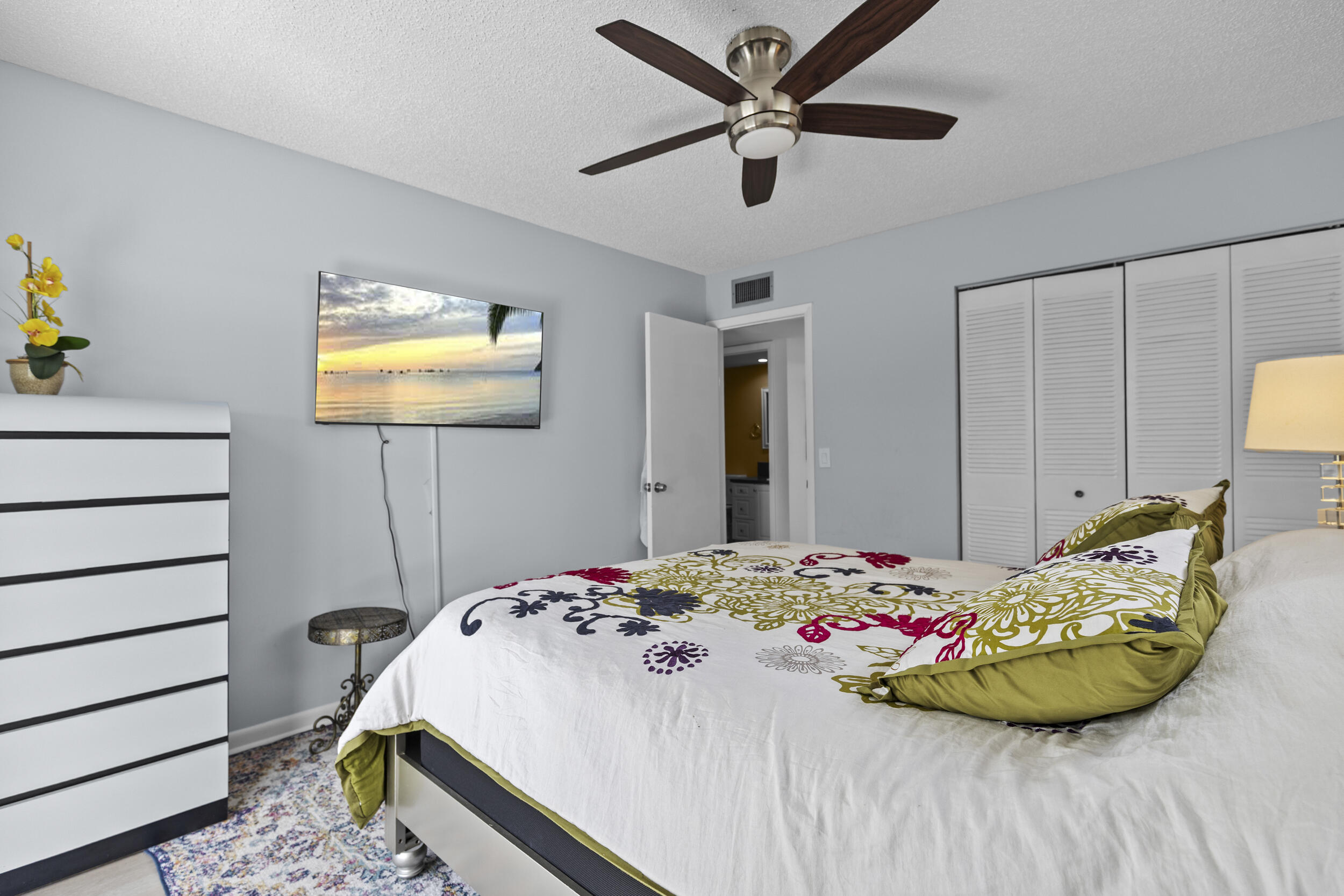 74 Normandy B Delray Beach, FL 33484 - Photo 11 of 21 a bedroom with a bed and a chandelier