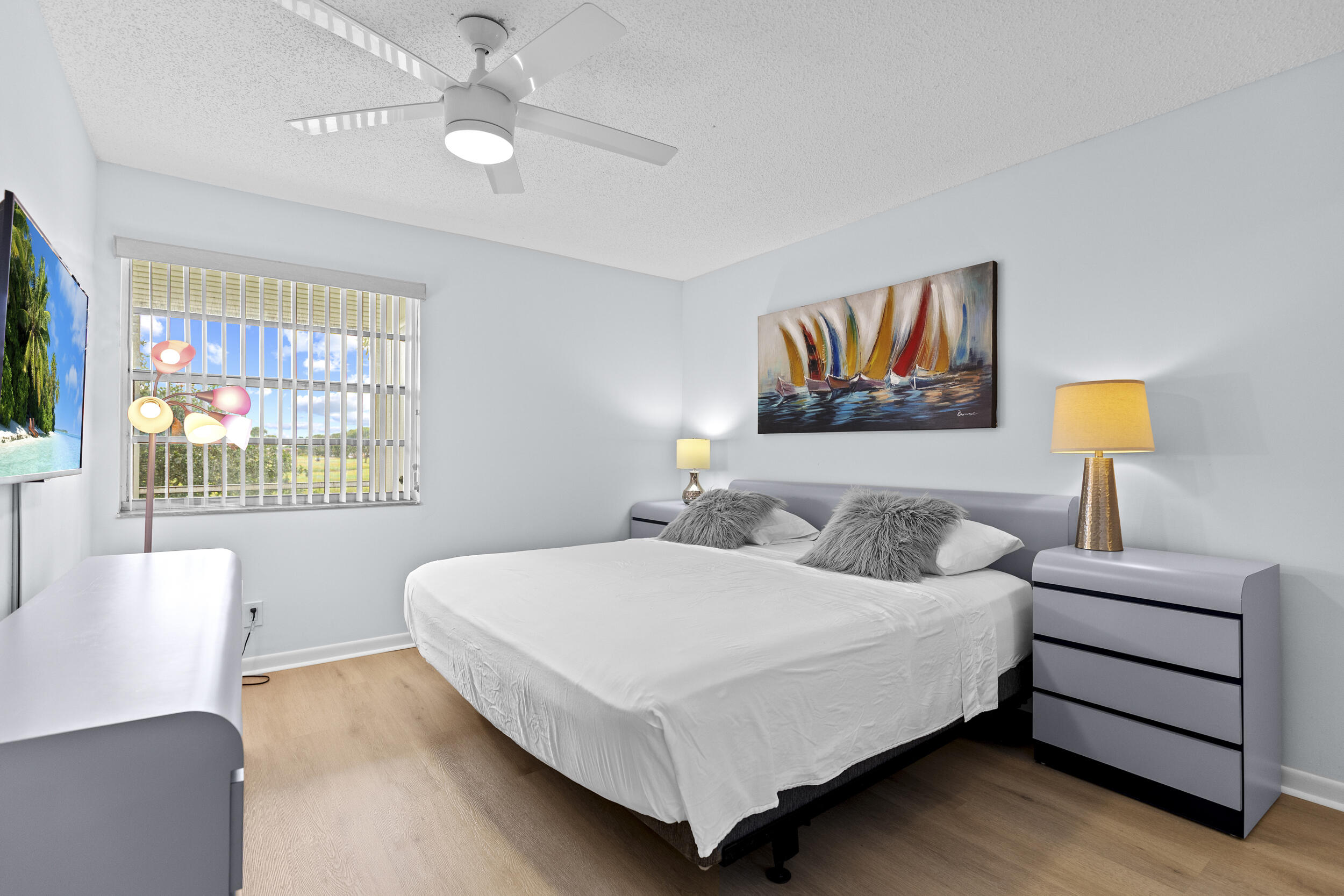 74 Normandy B Delray Beach, FL 33484 - Photo 14 of 21 a bedroom with a bed and a lamp