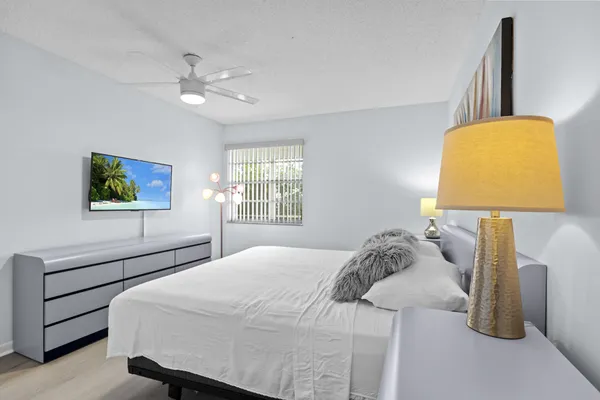 a bedroom with a bed and a lamp on table