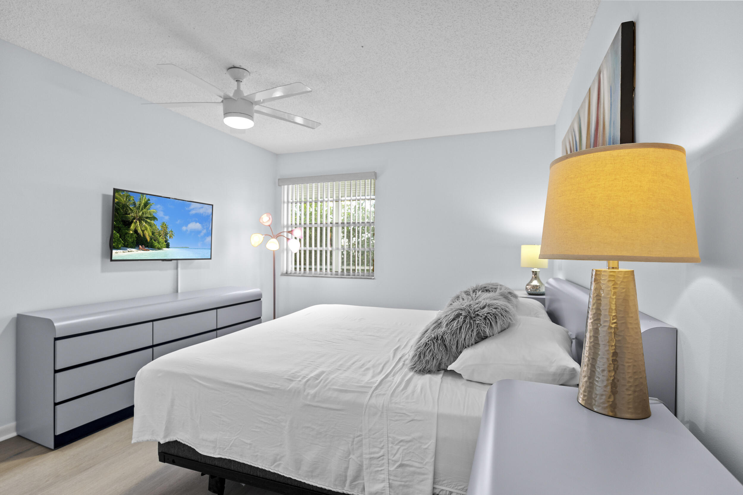 74 Normandy B Delray Beach, FL 33484 - Photo 15 of 21 a bedroom with a bed and painting on the wall