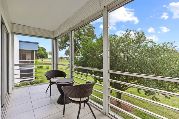 a view of a chair and table in the balcony
