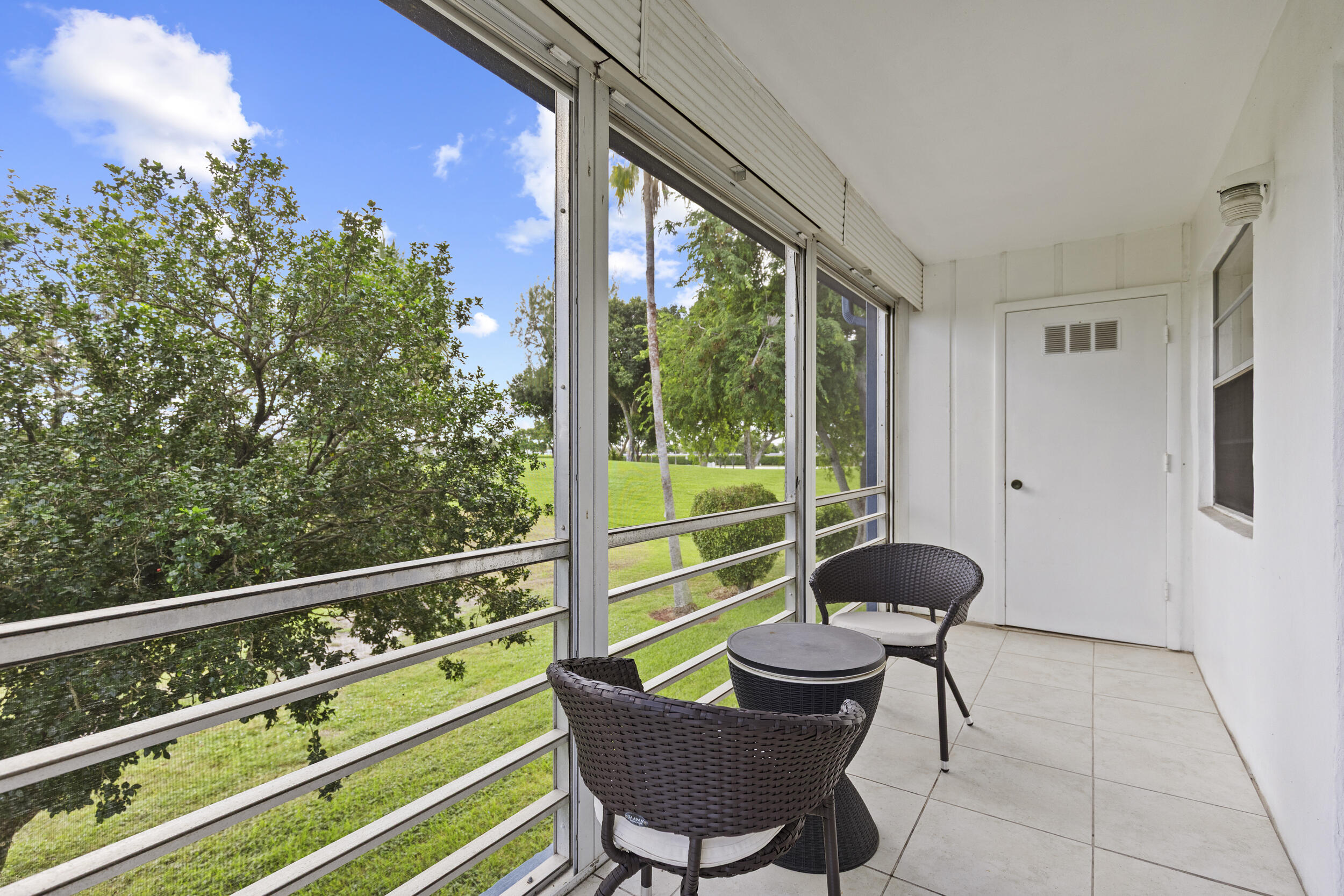 74 Normandy B Delray Beach, FL 33484 - Photo 18 of 21 a view of a chair and table in the balcony