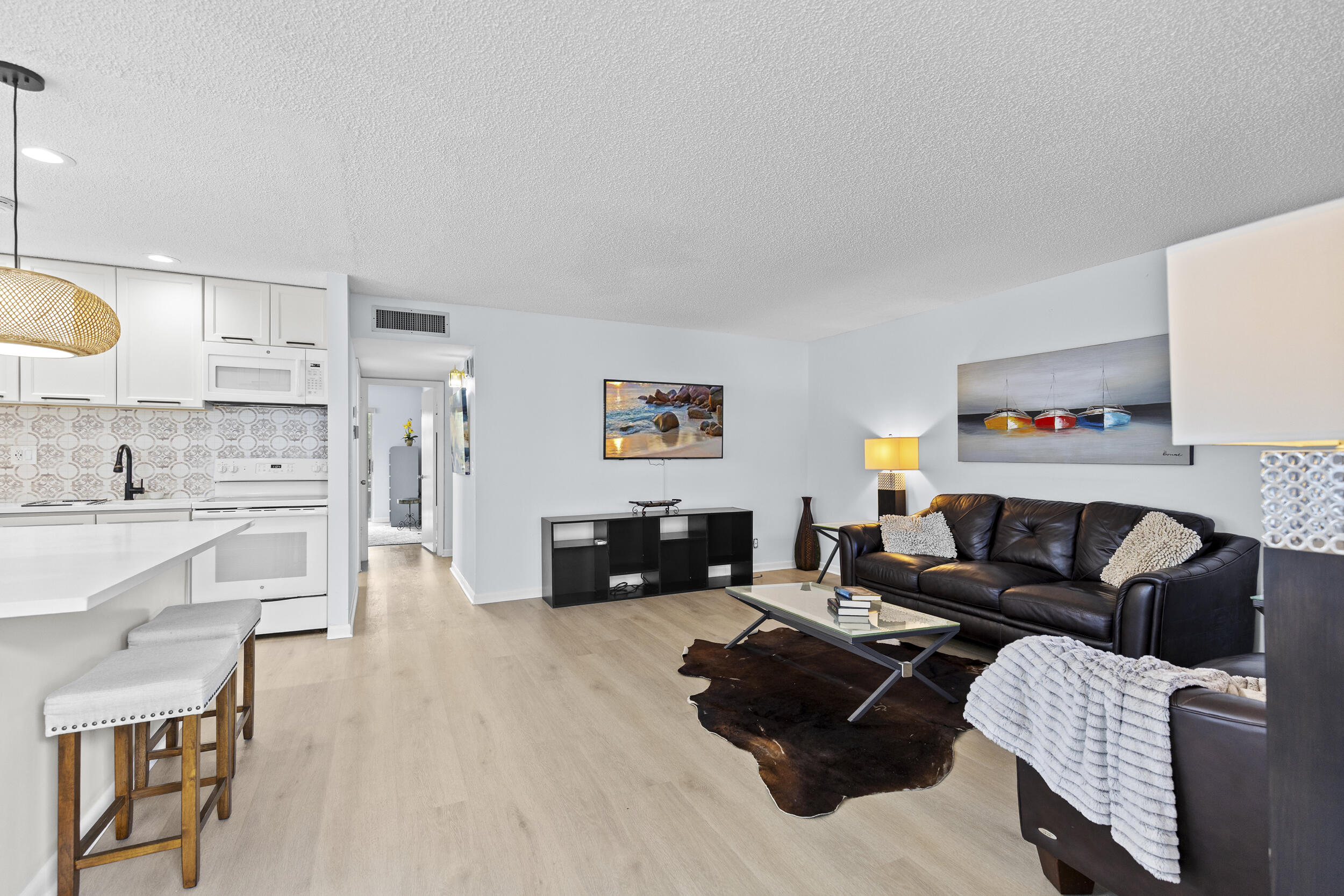 74 Normandy B Delray Beach, FL 33484 - Photo 4 of 21 a living room with furniture and a wooden floor
