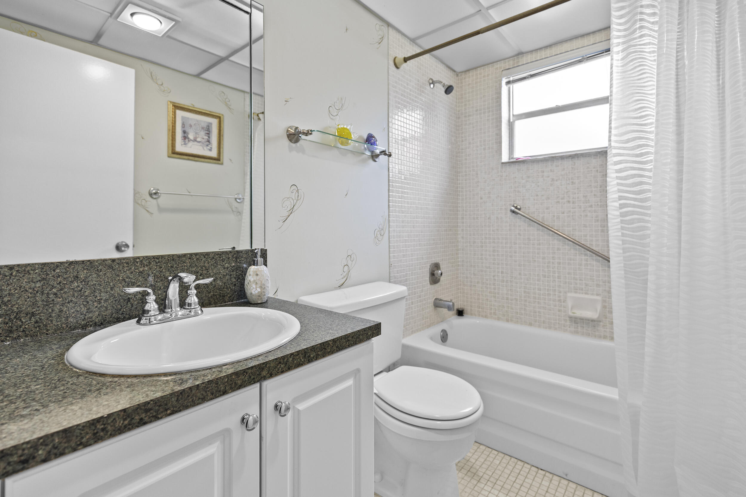 74 Normandy B Delray Beach, FL 33484 - Photo 8 of 21 a bathroom with a granite countertop sink toilet and shower