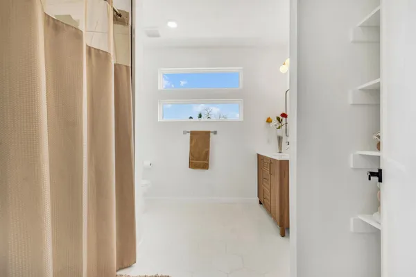 a bathroom with a sink vanity and mirror