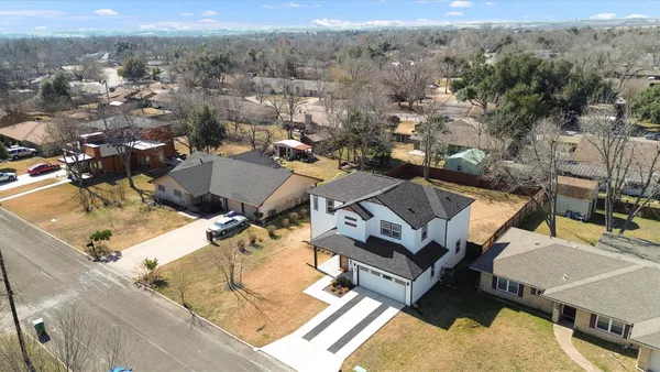 an aerial view of a houses with a yard