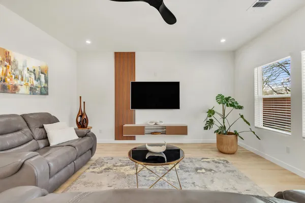a living room with furniture potted plant and a window