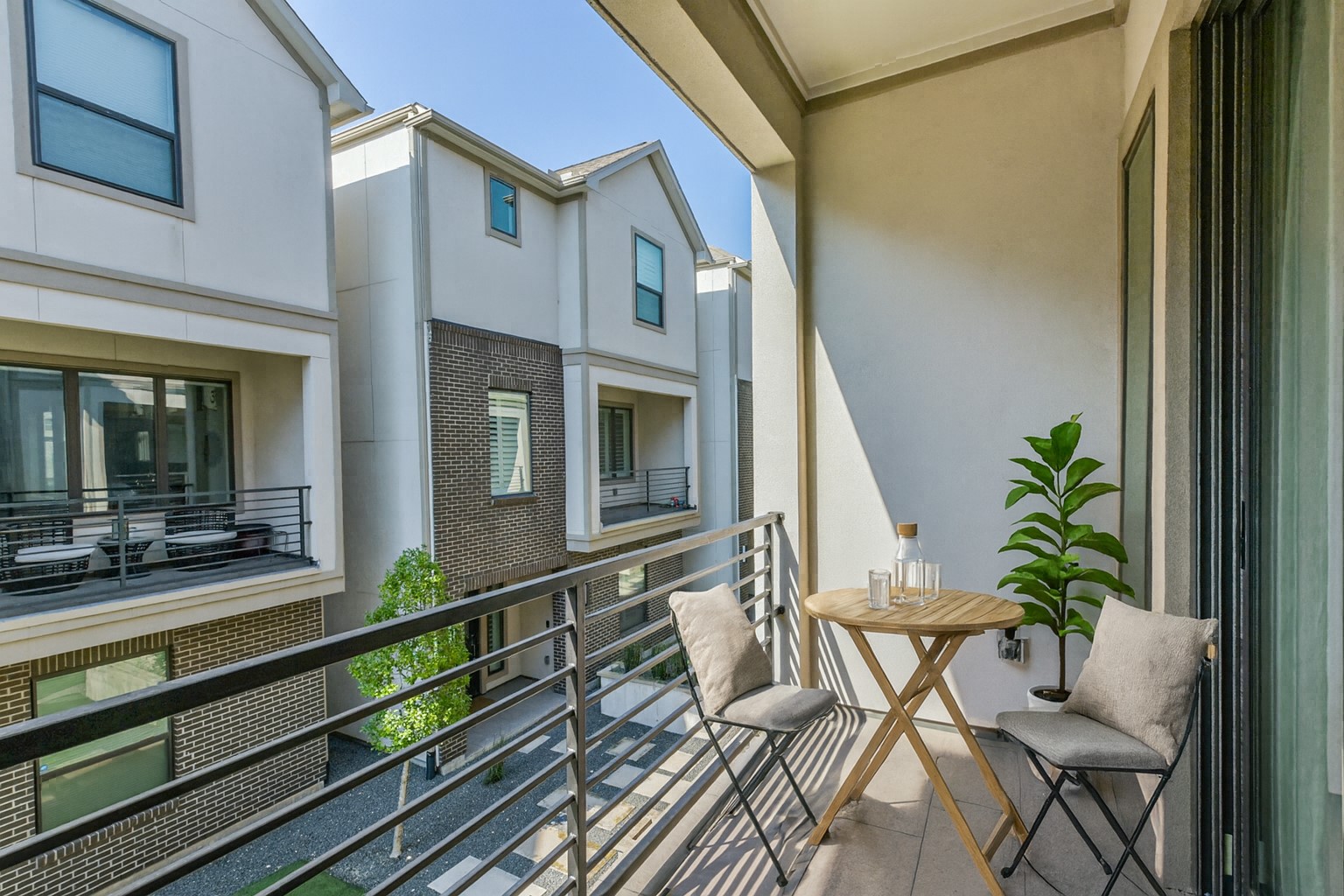 4219 Allen Street Houston, TX 77007 - Photo 14 of 29 Charming balcony overlooking the courtyard, offering the perfect spot for grilling, relaxing, or unwinding at the end of the day. Note this photo has been virtually staged