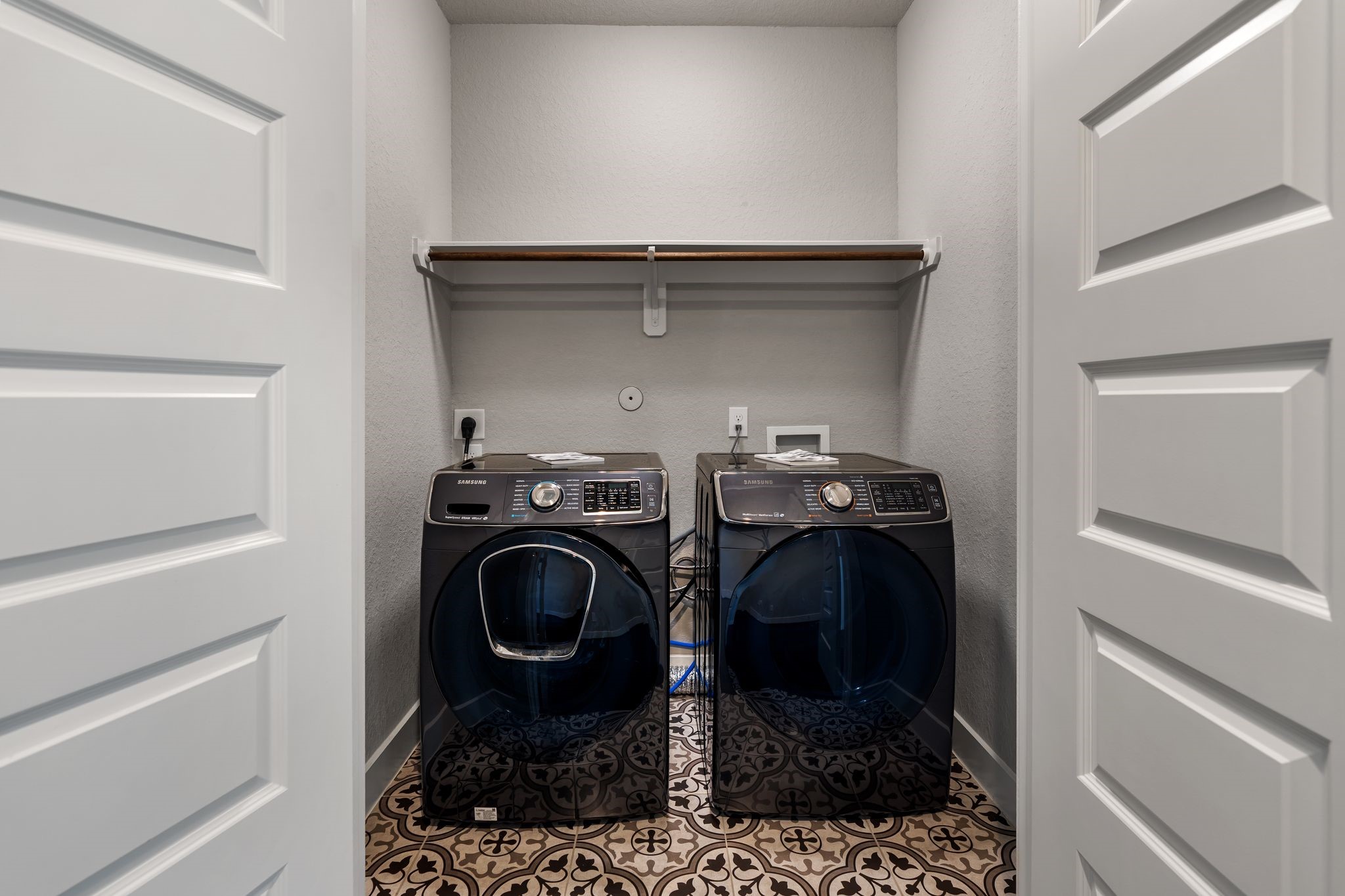 4219 Allen Street Houston, TX 77007 - Photo 23 of 29 On the third floor with the primary bedroom and guest bed is this stylish utility room with decorative tile floors, washer dryer hookups and dry bar.
