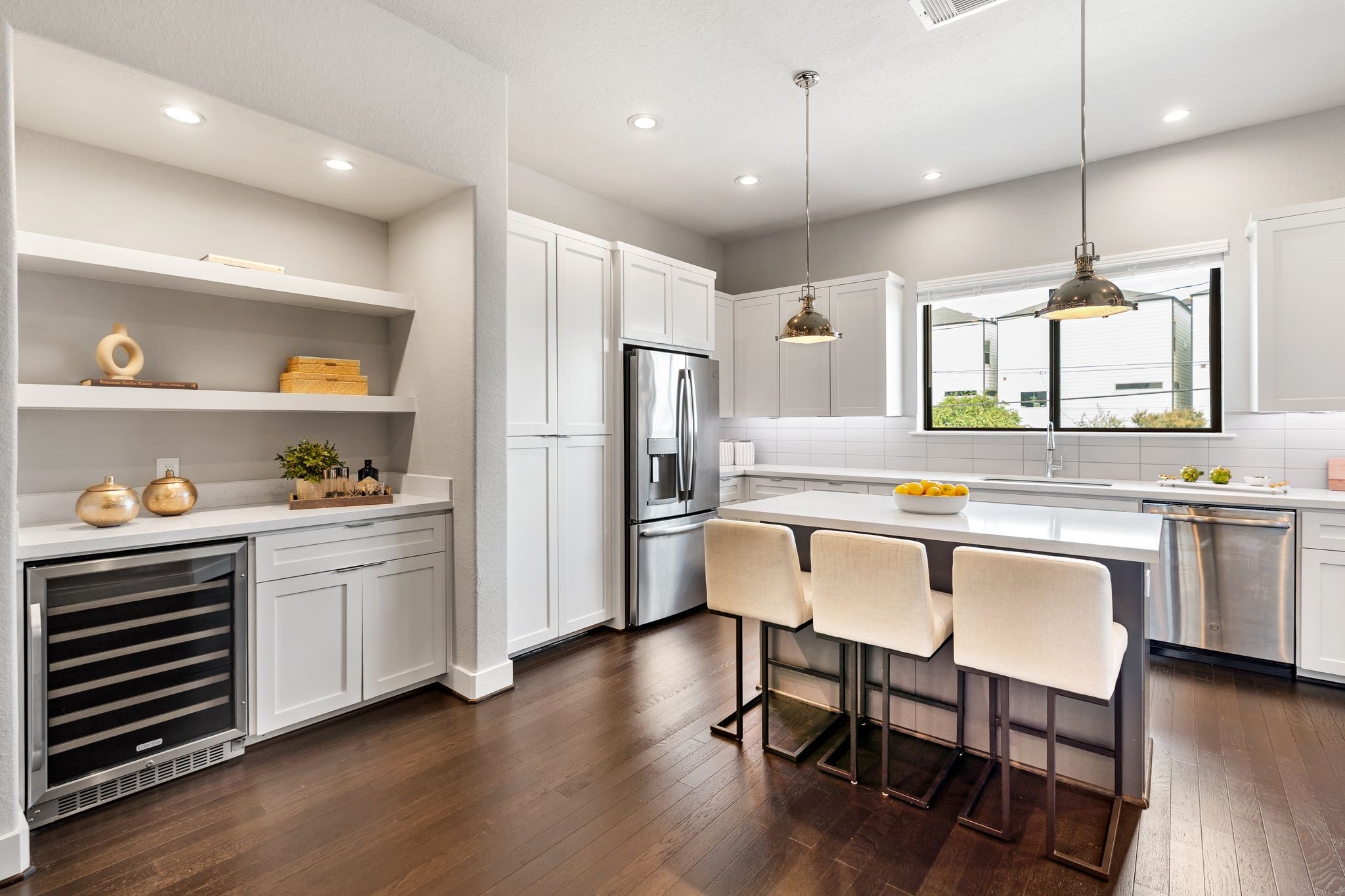 4219 Allen Street Houston, TX 77007 - Photo 5 of 29 Dedicated built-in bar with wine fridge, storage, and display shelving — an entertainer’s dream for hosting gatherings or enjoying a night in.