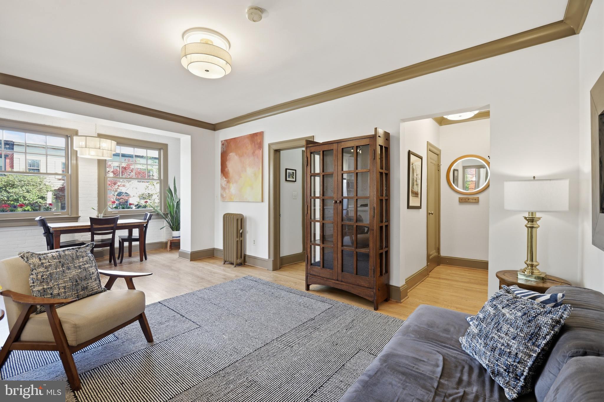 105 6th Street Southeast, Unit 108 Washington, DC 20003 - Photo 2 of 21 a spacious bedroom with a bed a table and chair