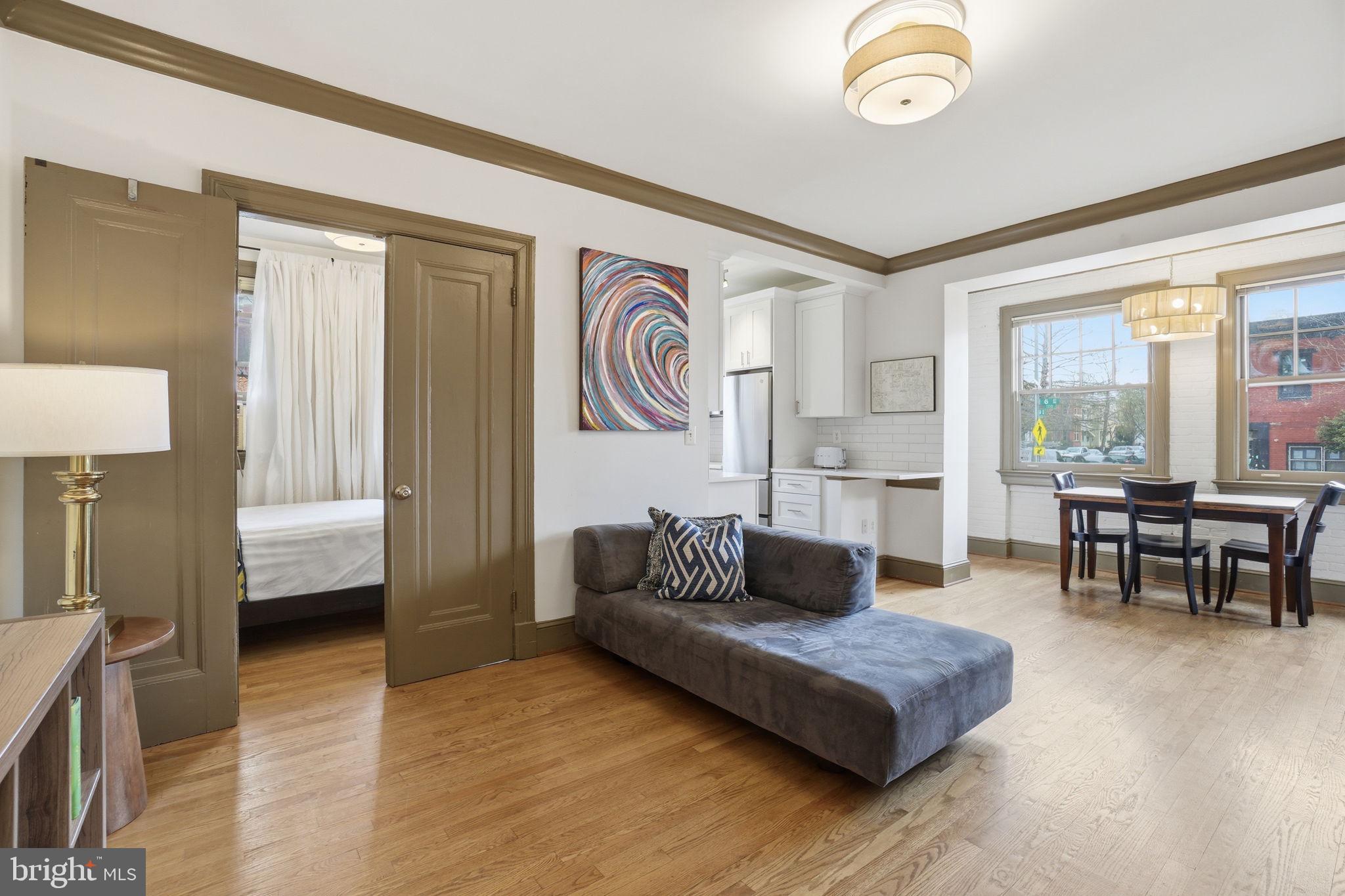 105 6th Street Southeast, Unit 108 Washington, DC 20003 - Photo 4 of 21 a living room with furniture and a large window