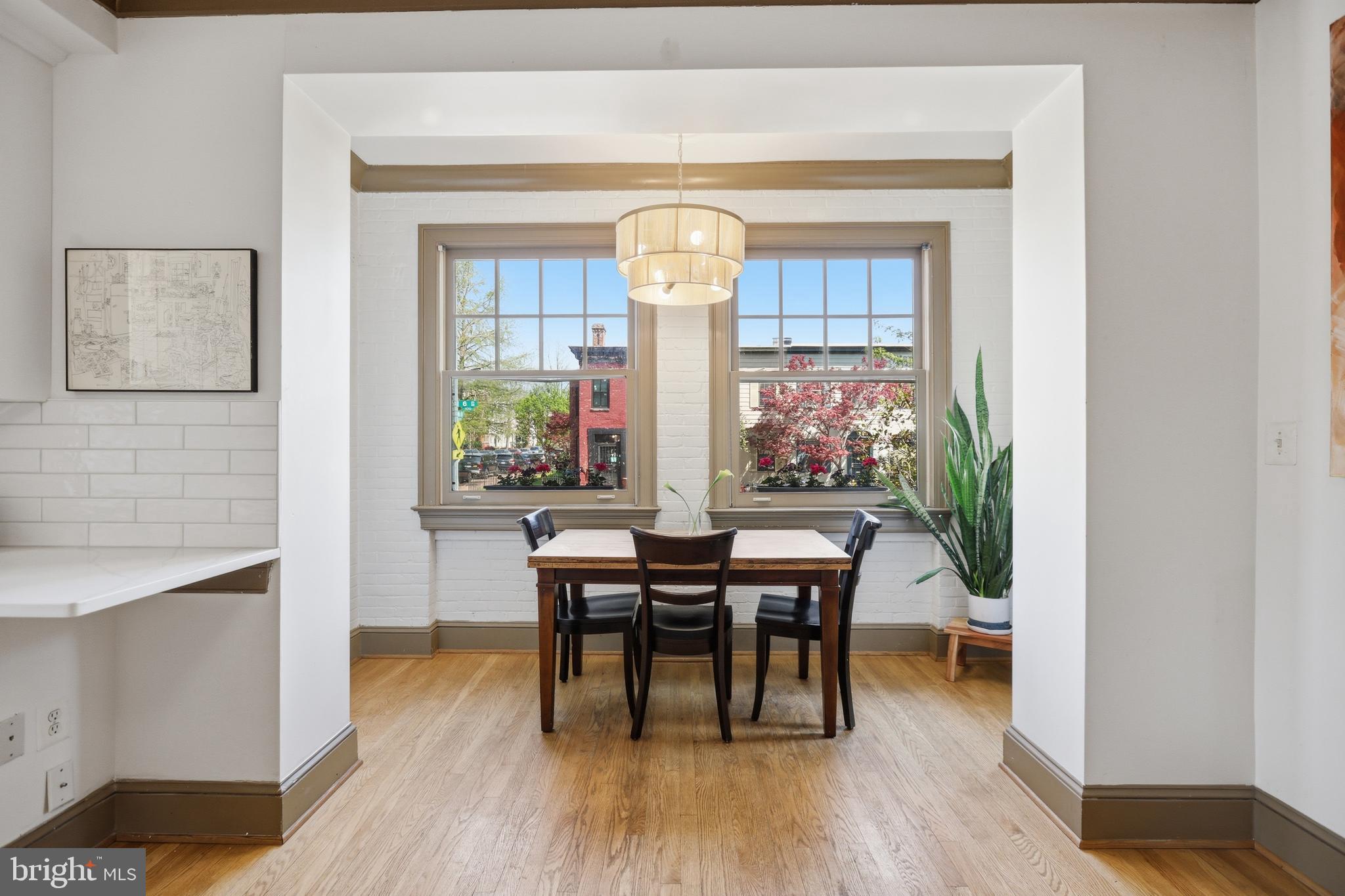 105 6th Street Southeast, Unit 108 Washington, DC 20003 - Photo 8 of 21 a view of a dining room with furniture window and wooden floor