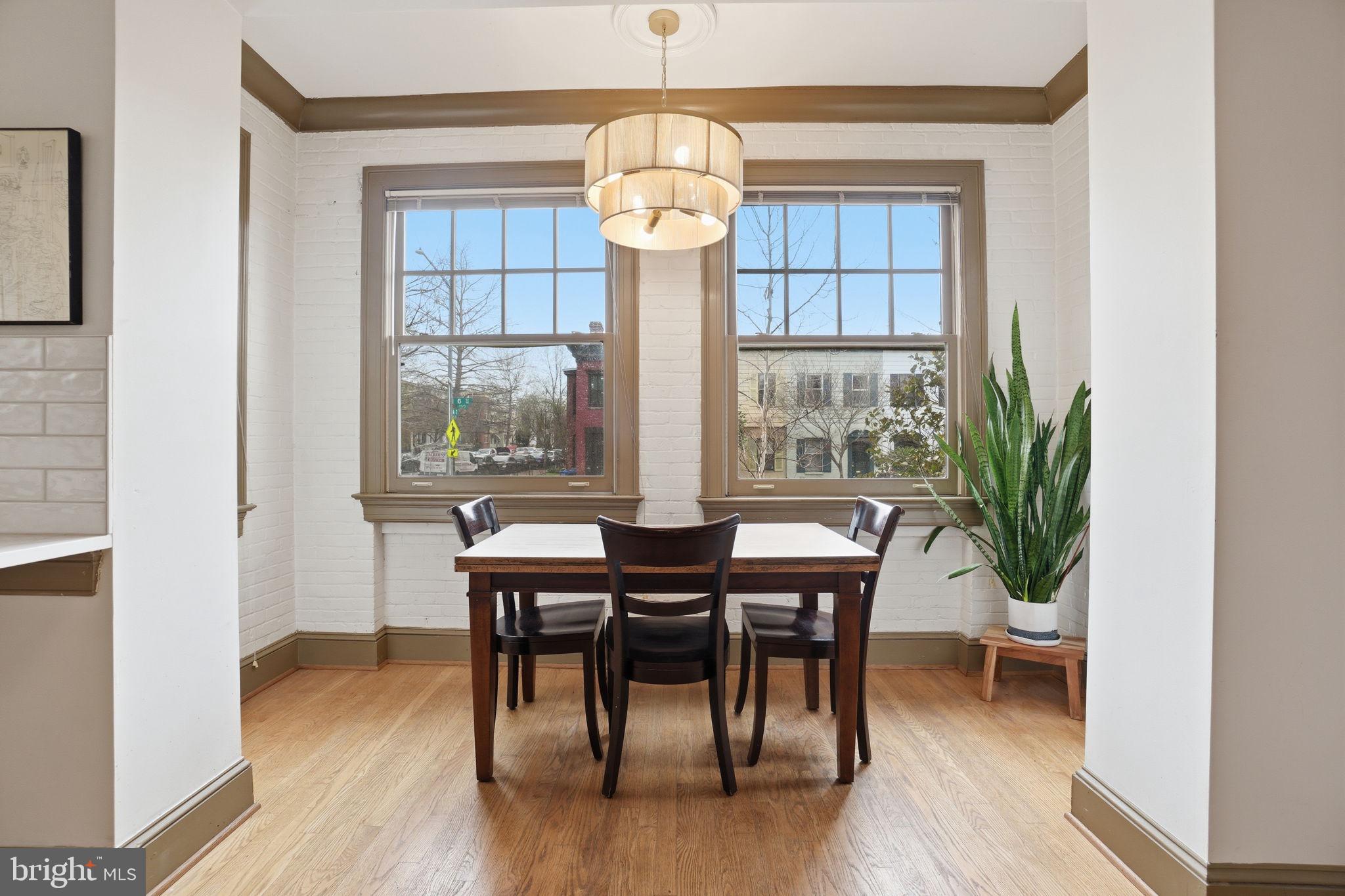 105 6th Street Southeast, Unit 108 Washington, DC 20003 - Photo 9 of 21 a view of a dining room with furniture window and wooden floor