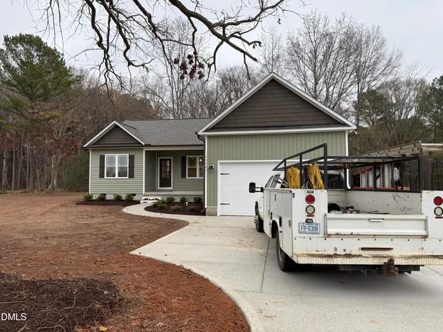 a view of a house with a yard covered in snow