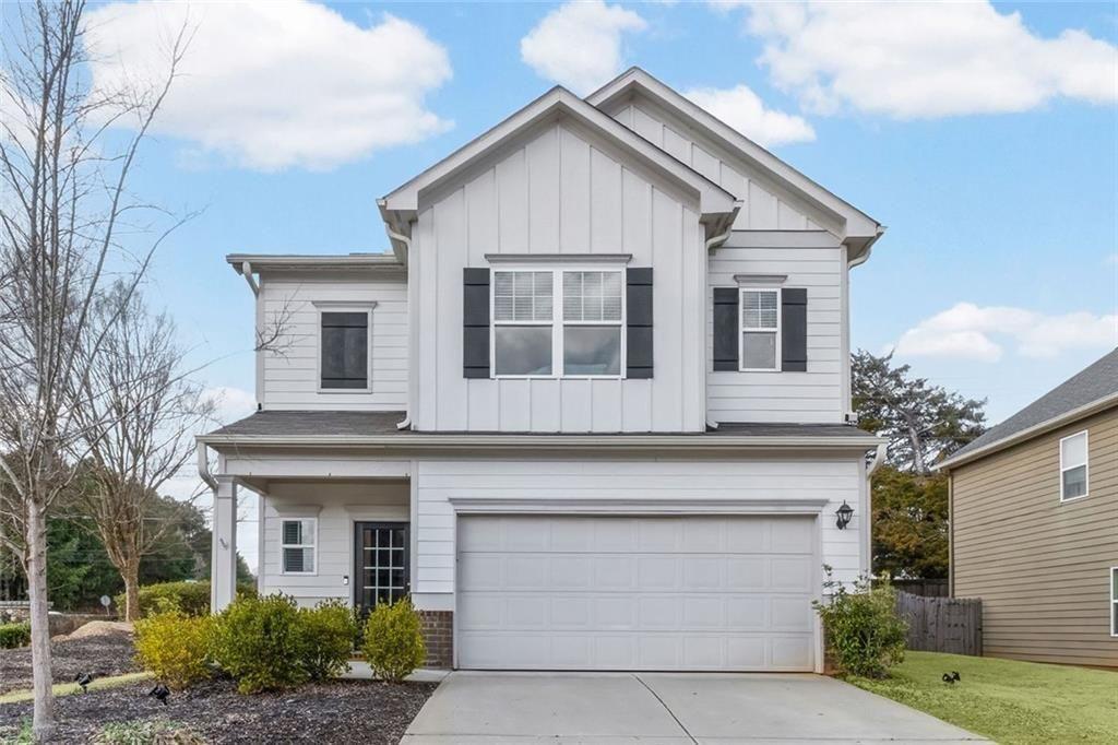 a view of house that has a lot of windows and plants