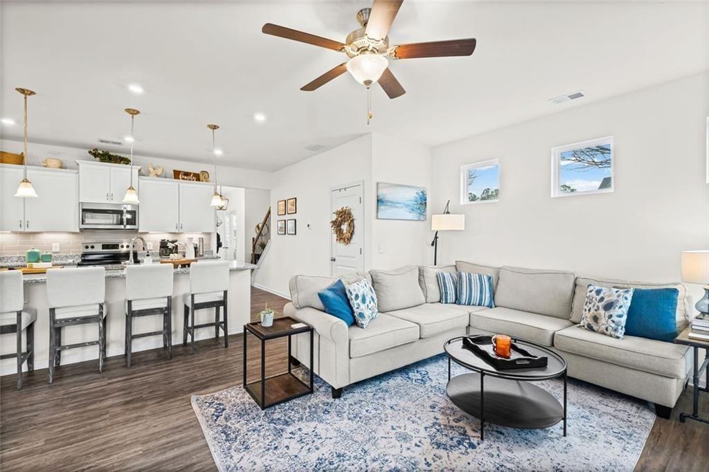 252 Renford Road Ball Ground, GA 30107 - Photo 11 of 36 a living room with furniture kitchen view and a wooden floor