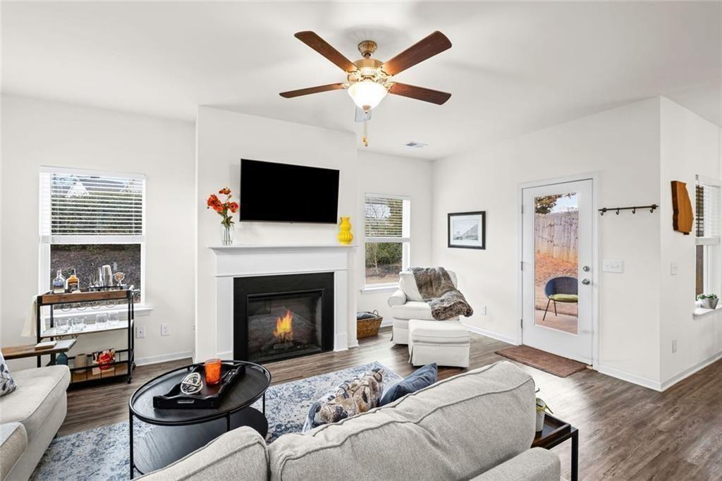 252 Renford Road Ball Ground, GA 30107 - Photo 12 of 36 a living room with furniture a fireplace and a flat screen tv