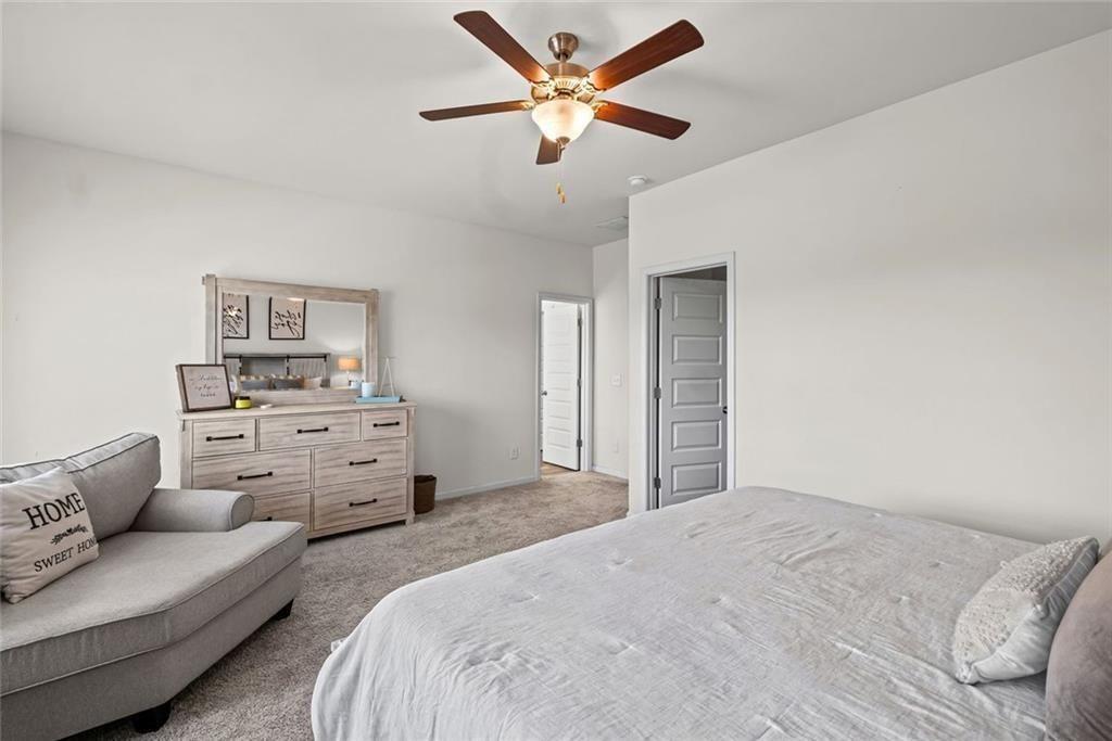 252 Renford Road Ball Ground, GA 30107 - Photo 16 of 36 a bedroom with a bed and ceiling fan