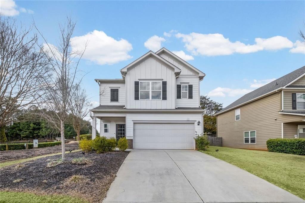 252 Renford Road Ball Ground, GA 30107 - Photo 33 of 36 a front view of a house with a yard and trees
