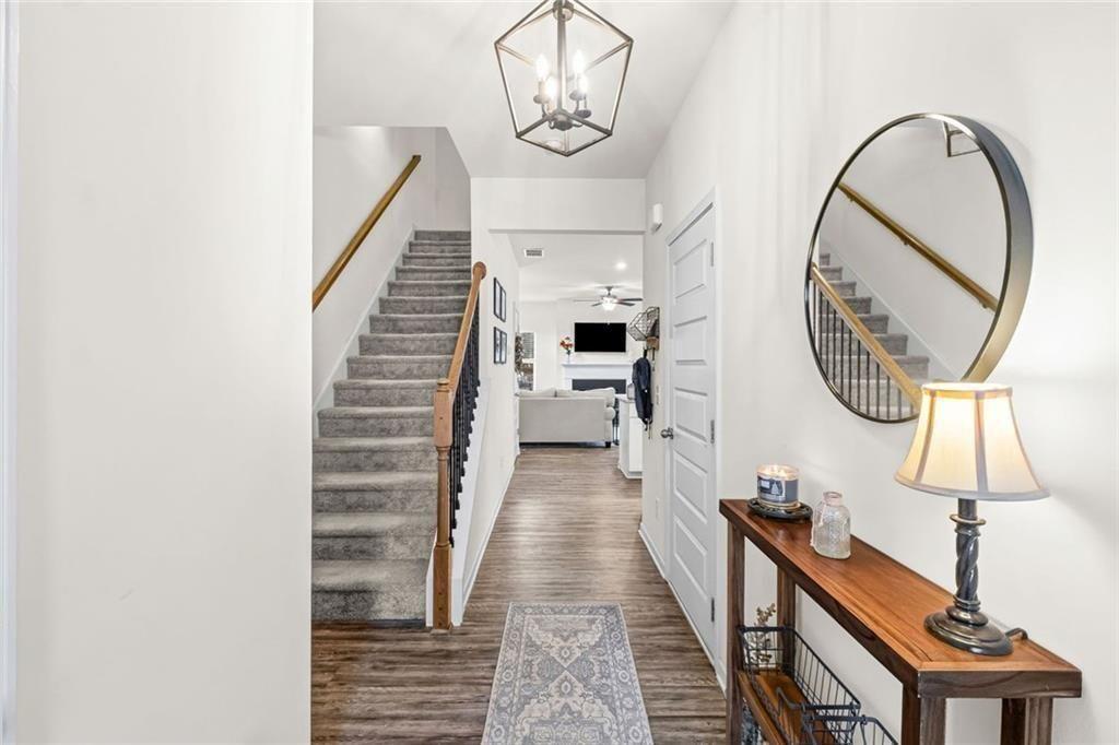 252 Renford Road Ball Ground, GA 30107 - Photo 4 of 36 a very nice looking room with a large mirror and a chandelier