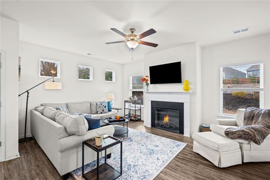 252 Renford Road Ball Ground, GA 30107 - Photo 10 of 36 a living room with furniture a flat screen tv and a fireplace