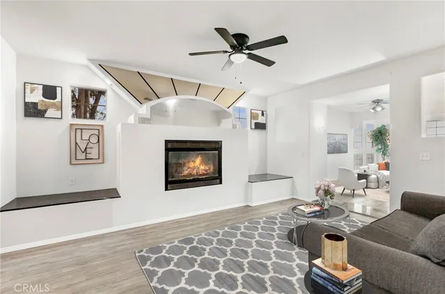 a living room with furniture and floor to ceiling windows
