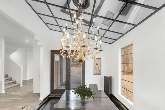 a view of a livingroom with wooden floor and a ceiling fan